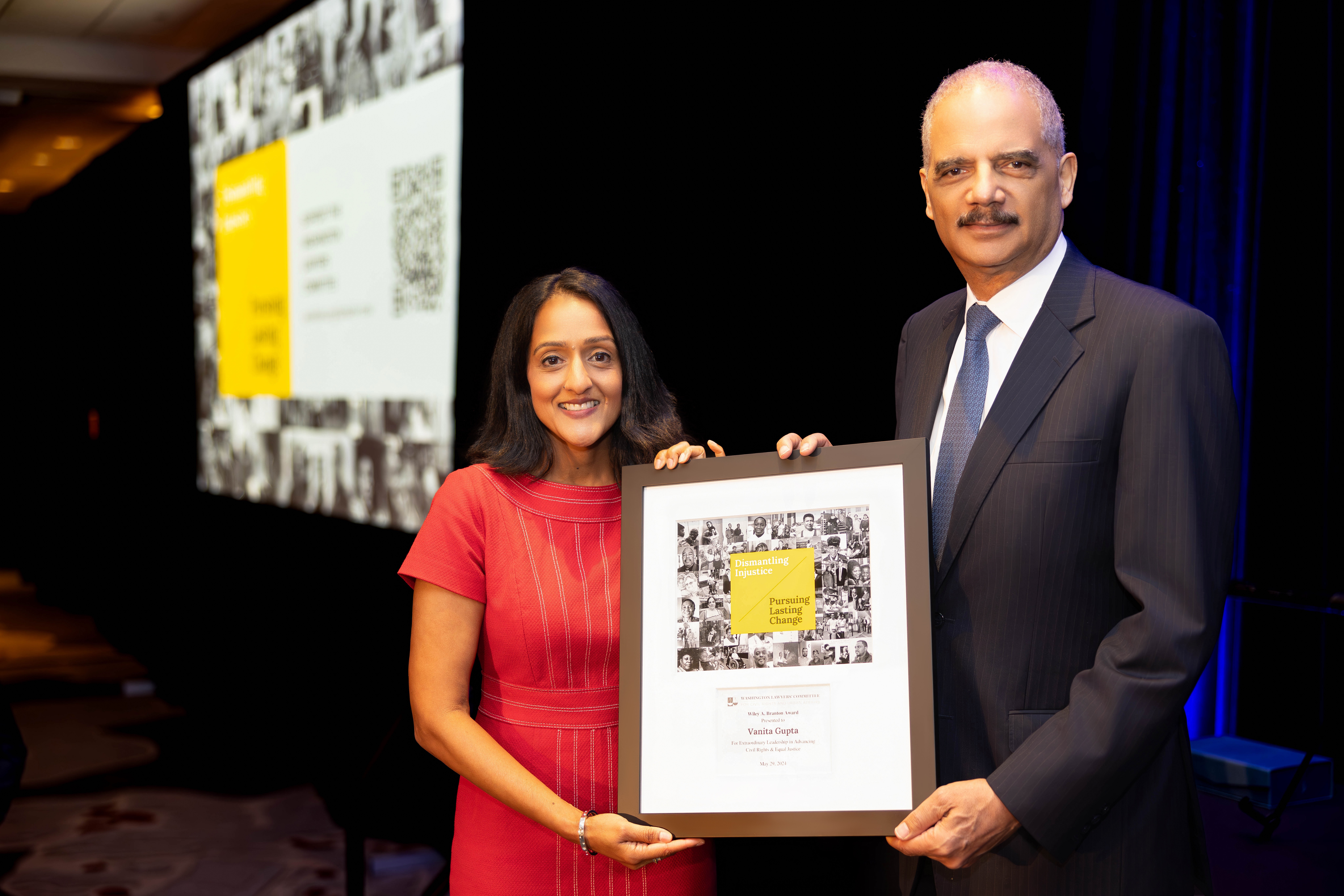 Photo of Vanita Gupta and AG Eric Holder at the 2024 Branton Luncheon holding the framed Branton Award